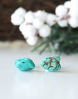 Natural turquoise stud earrings with sterling silver posts - front view showing raw turquoise stones and polished finish
