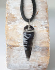 Detailed back view of black obsidian arrowhead pendant, handcrafted men’s necklace by Designs by Nature Gems.