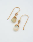 Angled look at opal drop earrings, artisan wire wrapping in 14k gold filled, October birthstone