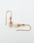 Closeup showing details of opal drop earrings, faceted opal stone, 14k gold filled setting
