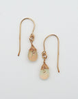Detailed front view of opal drop earrings, natural faceted opal with minimalist 14k gold filled wire wrapping, Designs by Nature Gems