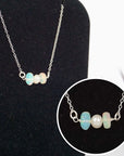 Close-up of raw opal stones and freshwater pearl bar on 925 sterling silver necklace