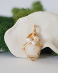 Detailed front angle of opal and freshwater pearl pendant, gold wire wrapped, handcrafted gemstone jewelry