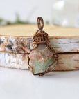 Detailed front view of natural opal pendant, artisan wire wrapped in antique bronze copper by Designs by Nature Gems.