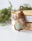 Side angle detail of natural opal pendant, wire wrapped in antique bronze copper by Designs by Nature Gems.