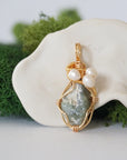 Detailed front angle of peridot and freshwater pearl pendant, gold wire wrapped, handcrafted gemstone jewelry