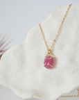 Side view of minimalist pink ruby pendant showing clean four-prong 14k gold vermeil setting — natural July birthstone necklace for women