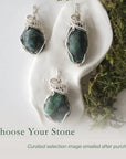 Three polished raw emerald pendants for women showing natural variation in emerald size, shape, and green colour in sterling silver wire wrapping