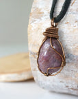 Left side view of large polished raw ruby pendant highlighting antique bronze wire wrap craftsmanship — men's statement crystal necklace, nickel-free copper wire