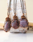 Three natural polished raw ruby pendants side by side showing unique variation in size, shape, and colour — each one of a kind by nature, men's crystal necklace