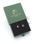 Rainbow moonstone drop earrings presented in a branded gift box, ready for gifting, with antique bronze copper wire wrapping.