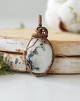 Back view of rainbow moonstone pendant necklace showing secure handcrafted antique bronze finish over copper wire wrapping