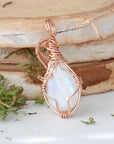Back view of rainbow moonstone cabochon pendant showing secure handcrafted 14k rose gold filled wire wrapping
