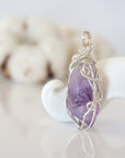 Right side detail of raw amethyst crystal pendant — intricate 925 sterling silver wire weaving technique, handcrafted artisan wire wrapped jewelry, Designs by Nature Gems