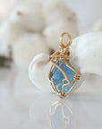 Side view of raw aquamarine pendant in 14k gold filled, showing artisan wire wrapping. Handcrafted March birthstone necklace by Designs by Nature Gems.