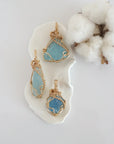 Three raw aquamarine pendants in 14k gold filled, showing natural variation in size, shape, and color. Handcrafted March birthstone jewelry by Designs by Nature Gems.