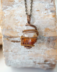 Back view of raw citrine pendant antique bronze wire wrapped showing artisan craftsmanship and copper wire detail