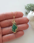 Raw emerald necklace in 14k gold filled shown in hand for size reference. Artisan May birthstone pendant by Designs by Nature Gems.
