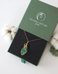 Raw emerald necklace in 14k gold filled displayed in branded Designs by Nature Gems jewelry box. Artisan May birthstone gift for women.
