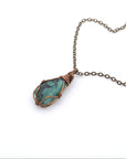 Raw emerald necklace in antique bronze copper wire wrapping by Designs by Nature Gems, handcrafted May birthstone pendant for all genders.