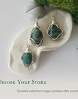 Three different raw emerald pendants displayed for variation reference
