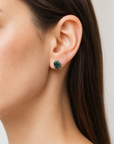 Female model wearing raw emerald stud earrings in 14k gold vermeil with natural emerald stones and minimalist design