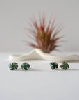 Two pairs of raw emerald stud earrings in 14k gold vermeil showing natural variation in emerald shape size and green colour