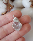 Raw Herkimer diamond necklace for women shown in hand for size reference with artisan wire wrapping in 925 sterling silver.