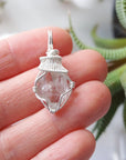 Raw Herkimer diamond necklace for women shown in hand for size reference with artisan wire wrapping in 925 sterling silver.