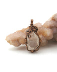 Back angle view of handmade Herkimer diamond pendant highlighting detailed wire wrapping in antique bronze copper.