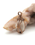 Right angle detail of raw Herkimer diamond pendant showing artisan wire wrapping in antique bronze copper.