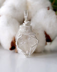 Front view of raw Herkimer diamond pendant for women with detailed artisan wire wrapping in 925 sterling silver.