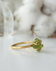 Left side angle of raw peridot adjustable ring — 14k gold vermeil artisan wire setting and smooth band detail, handcrafted August birthstone crystal ring for women
