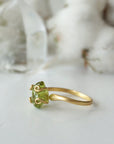 Right side angle of raw peridot adjustable ring — gold vermeil wire spiral setting and smooth band profile, dainty handcrafted August birthstone crystal ring for women