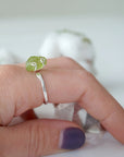 Raw peridot adjustable sterling silver ring worn on model's hand — natural olive green crystal, adjustable August birthstone crystal ring for women by Designs by Nature Gems