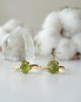 Two raw peridot adjustable rings showing natural variation in stone size, shape, and olive green colour — handcrafted 14k gold vermeil August birthstone crystal rings for women