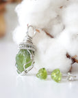 Left side detail of raw peridot pendant and stud earrings — 925 sterling silver coiled wire bail and lattice wrap detail, artisan crystal jewelry set for women