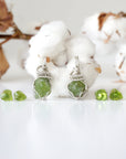 Two raw peridot jewelry sets for women showing natural variation in stone size, shape, and lime green colour — handcrafted 925 sterling silver August birthstone necklace and earring sets