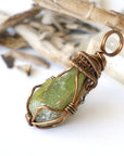 Left side detail of handmade raw peridot pendant for women — antique bronze copper wire weave and coiled bail, artisan crystal necklace by Designs by Nature Gems
