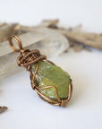 Right side detail of handmade raw peridot pendant for women — antique bronze wire wrapping technique and sculptural bail, artisan crystal jewelry by Designs by Nature Gems