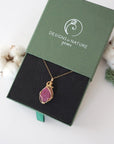 Raw pink ruby necklace in 14k gold filled displayed in branded Designs by Nature Gems jewelry box. Artisan July birthstone gift for women.