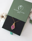 Raw pink ruby necklace in 14k gold filled displayed in branded Designs by Nature Gems jewelry box. Artisan July birthstone gift for women.