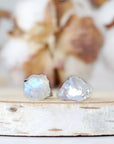 Front view close-up of raw rainbow moonstone stud earrings featuring natural uncut moonstone stones on 925 sterling silver posts.