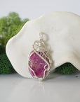 Front view of raw pink ruby pendant — natural unpolished ruby stone hand-wrapped in detailed 925 sterling silver wire, handcrafted artisan jewelry