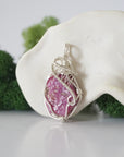 Left side detail of handmade raw ruby necklace — artisan wire wrapped 925 sterling silver pendant, natural ruby stone, ethically sourced crystal jewelry
