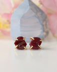Front view of raw ruby prong stud earrings showing open claw 14k gold vermeil setting — minimalist natural crystal earrings for women
