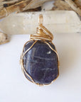 Back view of women's raw sapphire pendant showing the detail of 14k gold-filled wire-wrapping — one-of-a-kind handcrafted crystal jewelry