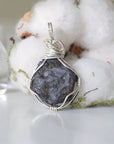 Back view of women's raw sapphire pendant showing the detail of 925 sterling silver wire-wrapping — one-of-a-kind handcrafted crystal jewelry