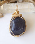 Front view of raw sapphire pendant in 14k gold-filled wire wrap — women's handcrafted crystal jewelry by Designs by Nature Gems