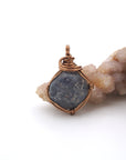 Front view of a raw sapphire pendant wire wrapped in antique bronze — natural crystal necklace handcrafted in Toronto